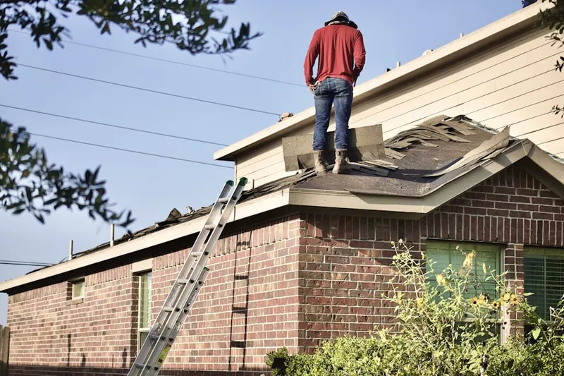Professional roofer working on a residential roof in Winder Village
